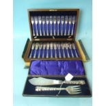 A set of twelve each fish knives and forks in fitted mahogany case and a cased set of fish