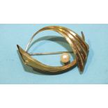 A 1960's 9ct gold brooch of abstract form set a cultured pearl, 3.8cm, 4.2g.