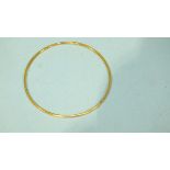 A small gold bangle, 5.5cm diameter, unmarked, (tests as 18ct, approximately).