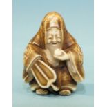 A mid to late-19th century ivory netsuke of Jurojin holding a fan and a tama, his robes finely-