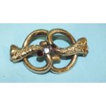 A Victorian gold brooch with engraved decoration set three foiled garnets (damaged), 45mm, (tested