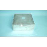 A silver cigar box by Mappin & Webb, of plain form with ribbed lid around square cartouche, (no