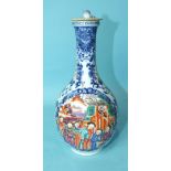 A 19th century Chinese famille-decorated bottle vase and cover, decorated with polychrome panel of