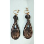 A pair of 19th century Whitby jet earrings, each with carved female profile, on plated screw