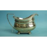 A late-George-III silver cream jug with gadrooned rim, on four ball feet, 9.5cm high, London 1819,