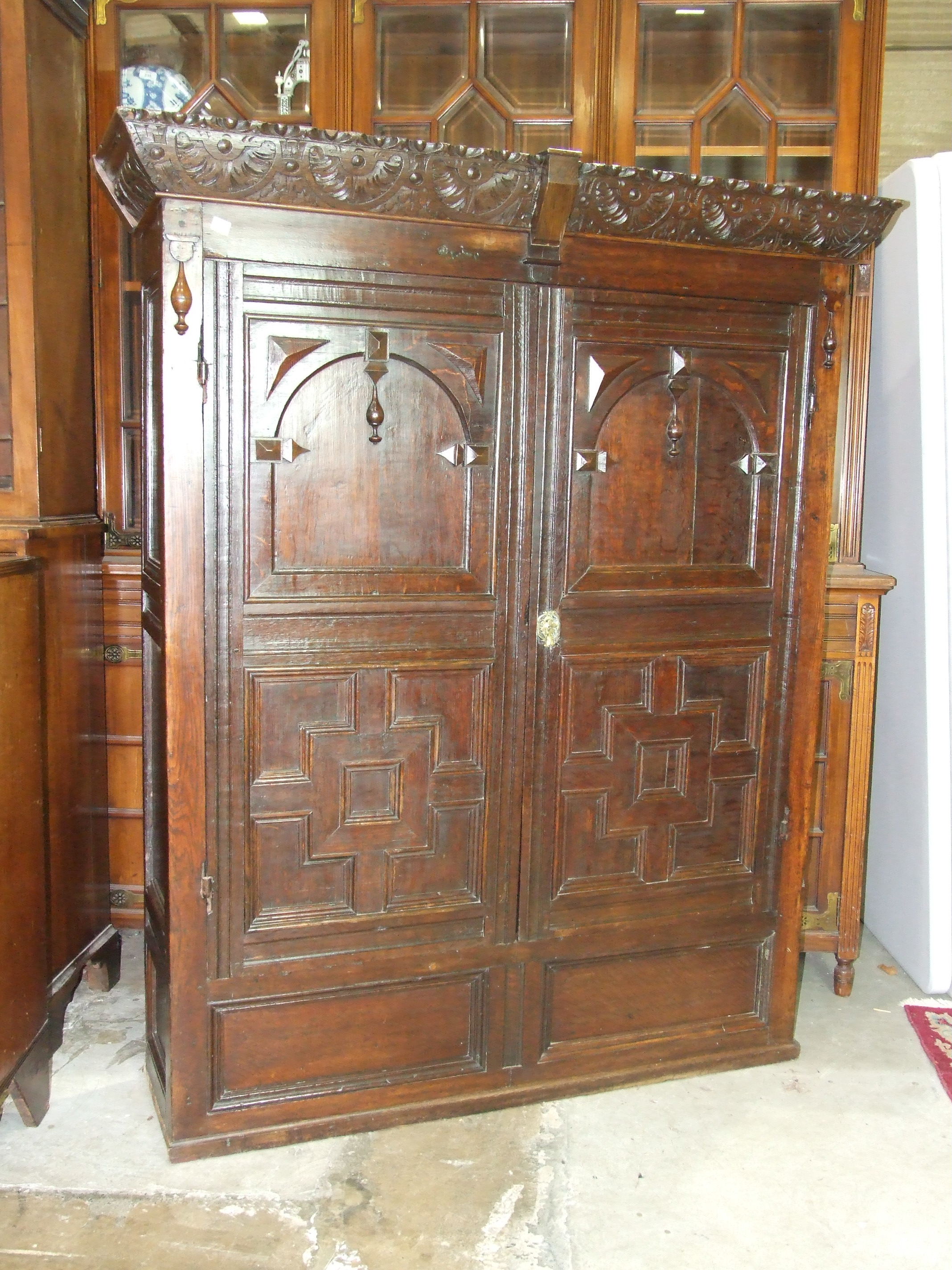An antique oak cupboard, the carved cornice above a pair of panelled doors, 136cm wide, 165cm high. - Image 2 of 2