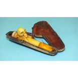 A small meerschaum cheroot holder adorned with a carved skull and crossbones and having an amber