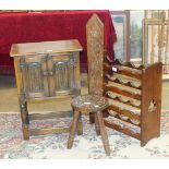 An oak bedside two-door cupboard, 50cn wide, a wine rack and a three-legged milking stool, (3).