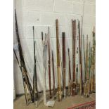 A collection of approximately 25 fibreglass boat rods, pier rods and spinning rods.