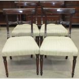 A set of four reproduction mahogany dining chairs with upholstered seats on turned legs.