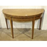 A 19th century mahogany circular fold-over dining table on square tapering legs, 131cm diameter ,a