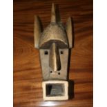 An African carved wood mask, 47cm high.