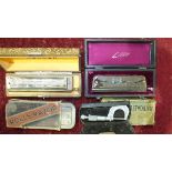 A Hohner 64-chromonica in case, another harmonica, a Moore & Wright micrometer and a boxed Rolls