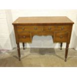 A Victorian mahogany dressing table, the rectangular cross-banded top above four drawers, on