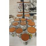A collection of sixteen Portmeirion "Botanic Garden" food jars with beechwood covers.