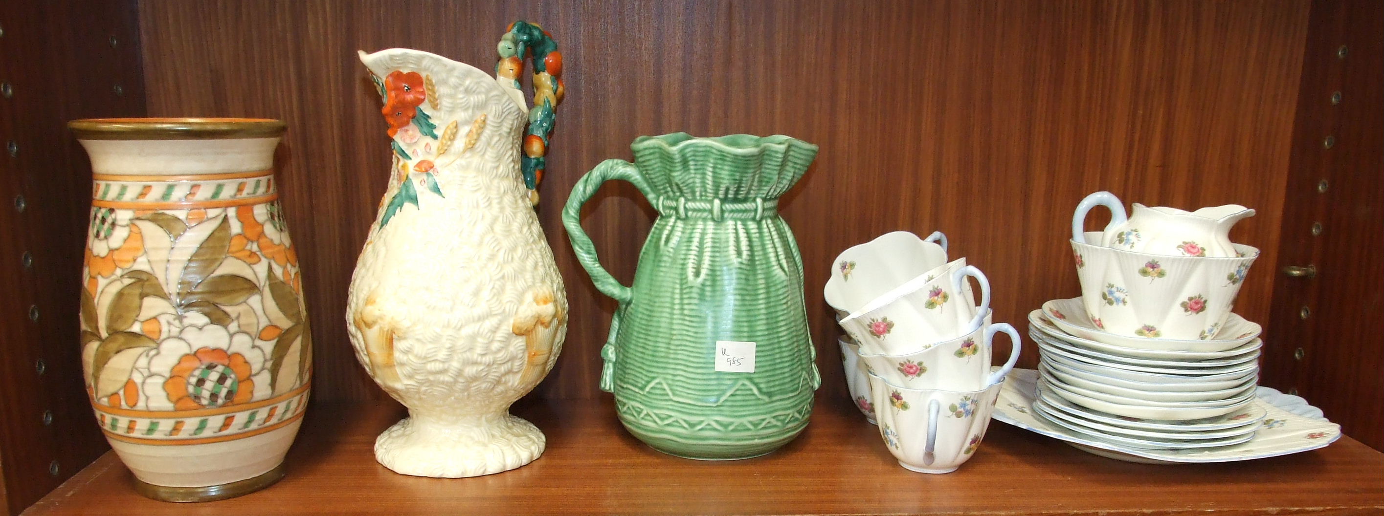 A Charlotte Rhead baluster ribbed vase, (hairline crack), a Clarice Cliff harvest jug and other