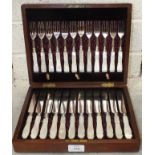 A set of twelve each mother-of-pearl-handled plated dessert knives and forks, in mahogany fitted