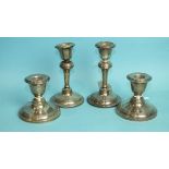 A pair of short silver loaded candlesticks, Chester 1910, 8cm high and another pair, Chester 1922,