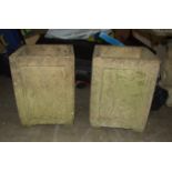 A pair of cast concrete square planters moulded with putti, 30cm², 40cm high, (2).