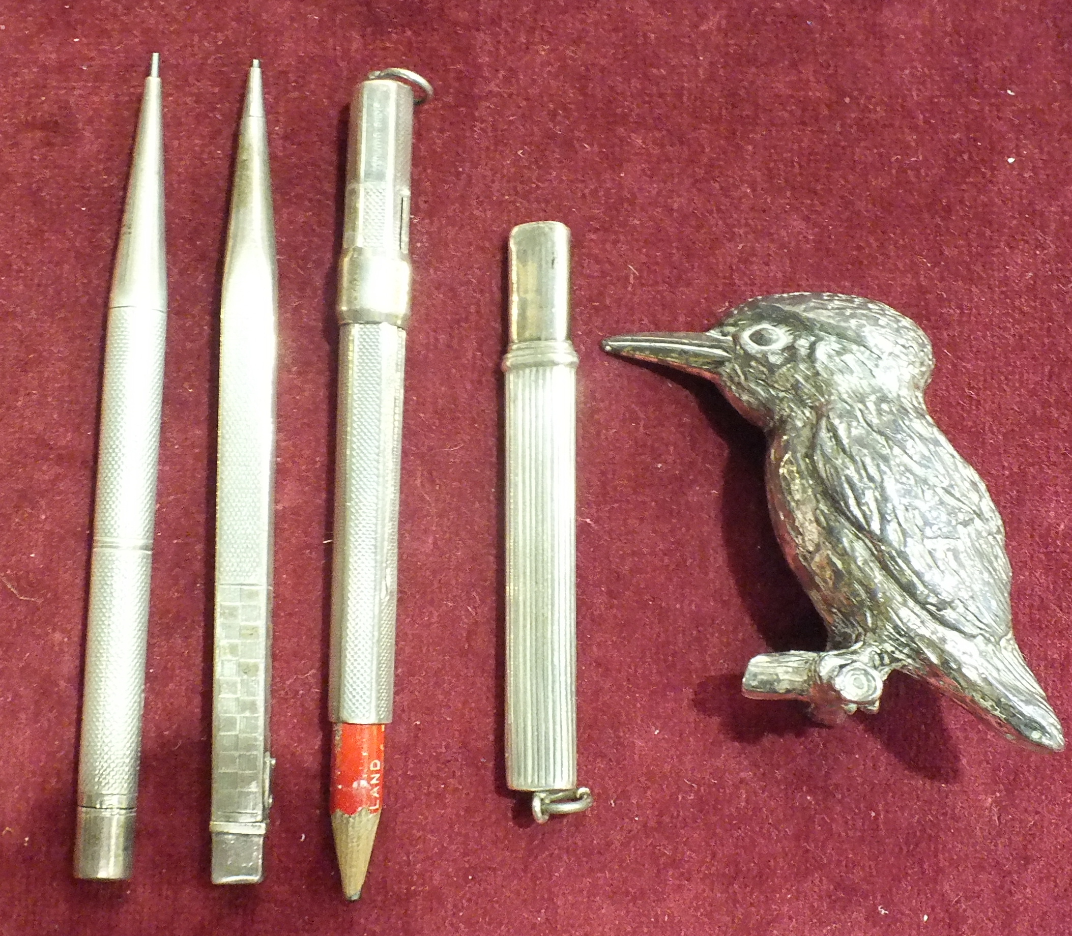 Two silver pencil holders, a silver propelling pencil and other items.