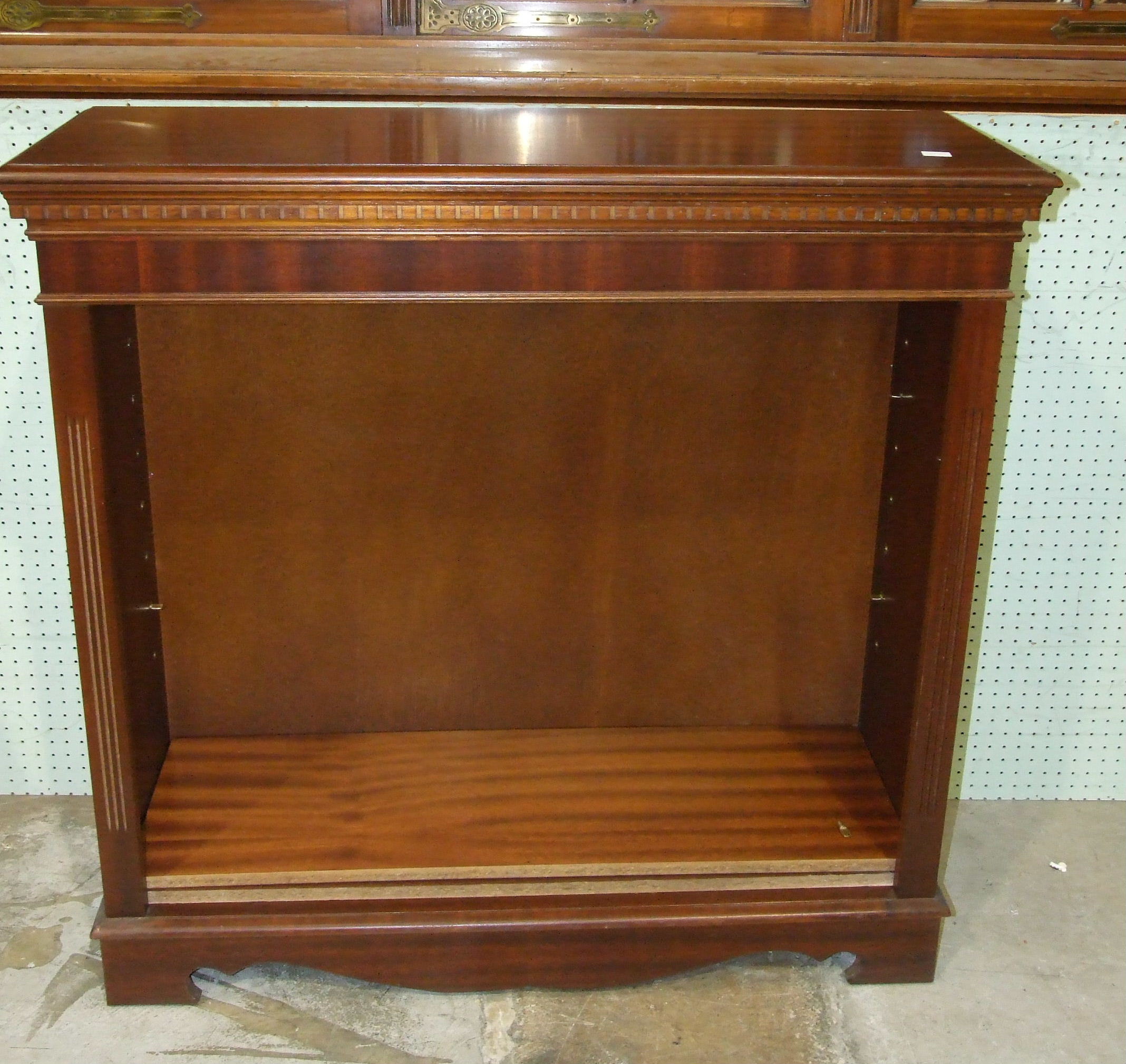 A reproduction mahogany finished low bookcase, 94cm wide, 94cm high.