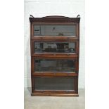 A mahogany four-tier Globe Wernicke-style sectional bookcase with dentil frieze above four