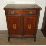 An Edwardian inlaid mahogany two-door cupboard fitted with a drawer and fold-over top, on bracket