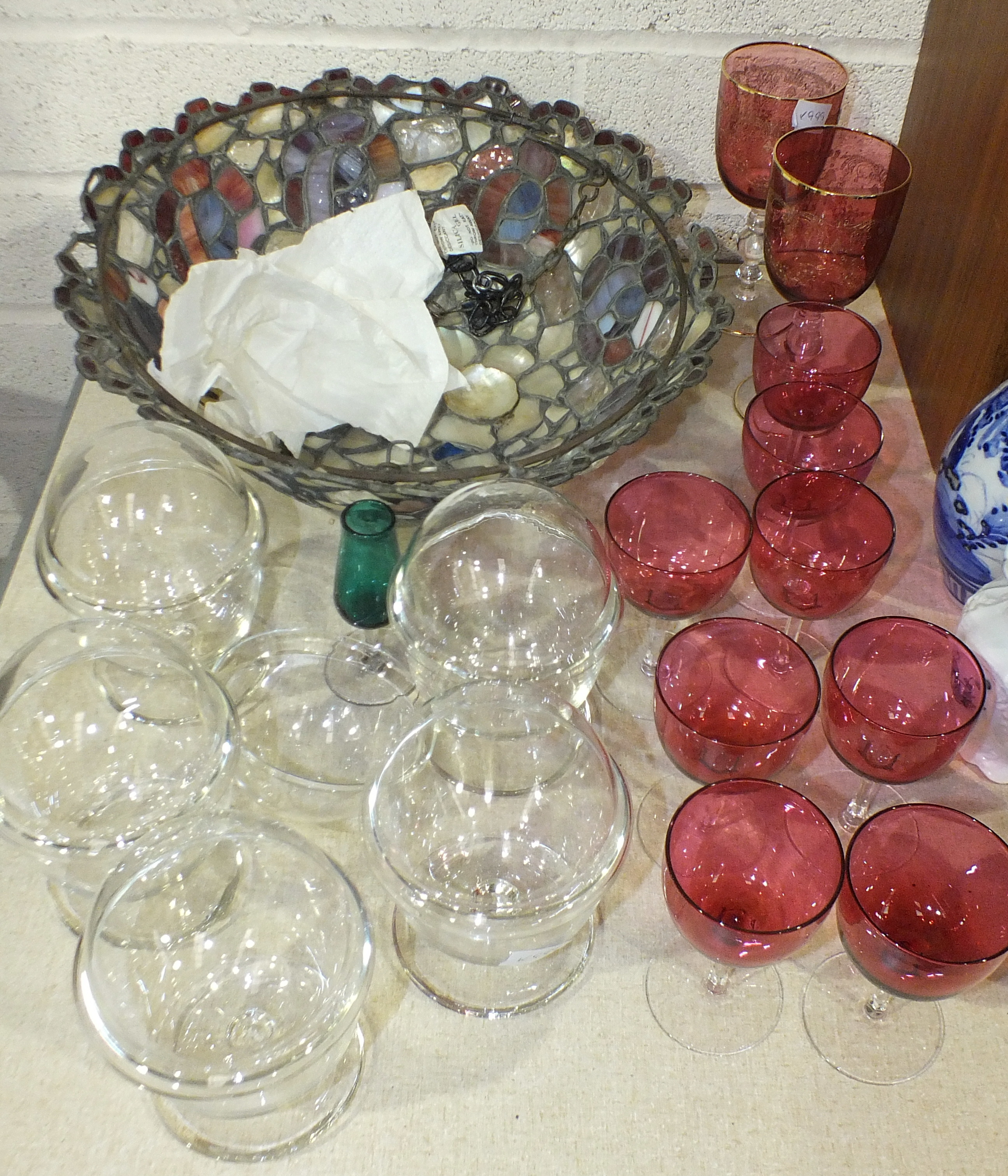 Eight cranberry port glasses, a mosaic glass and mother of pearl lamp shade (damaged), 30cm and