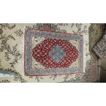 A modern Oriental wool rug of Kashan design, 124 x 204cm and two other modern rugs, (3).