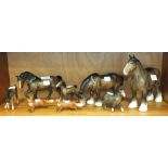 Two Beswick models of heavy horses and a foal, another Beswick bay horse and foal, together with two