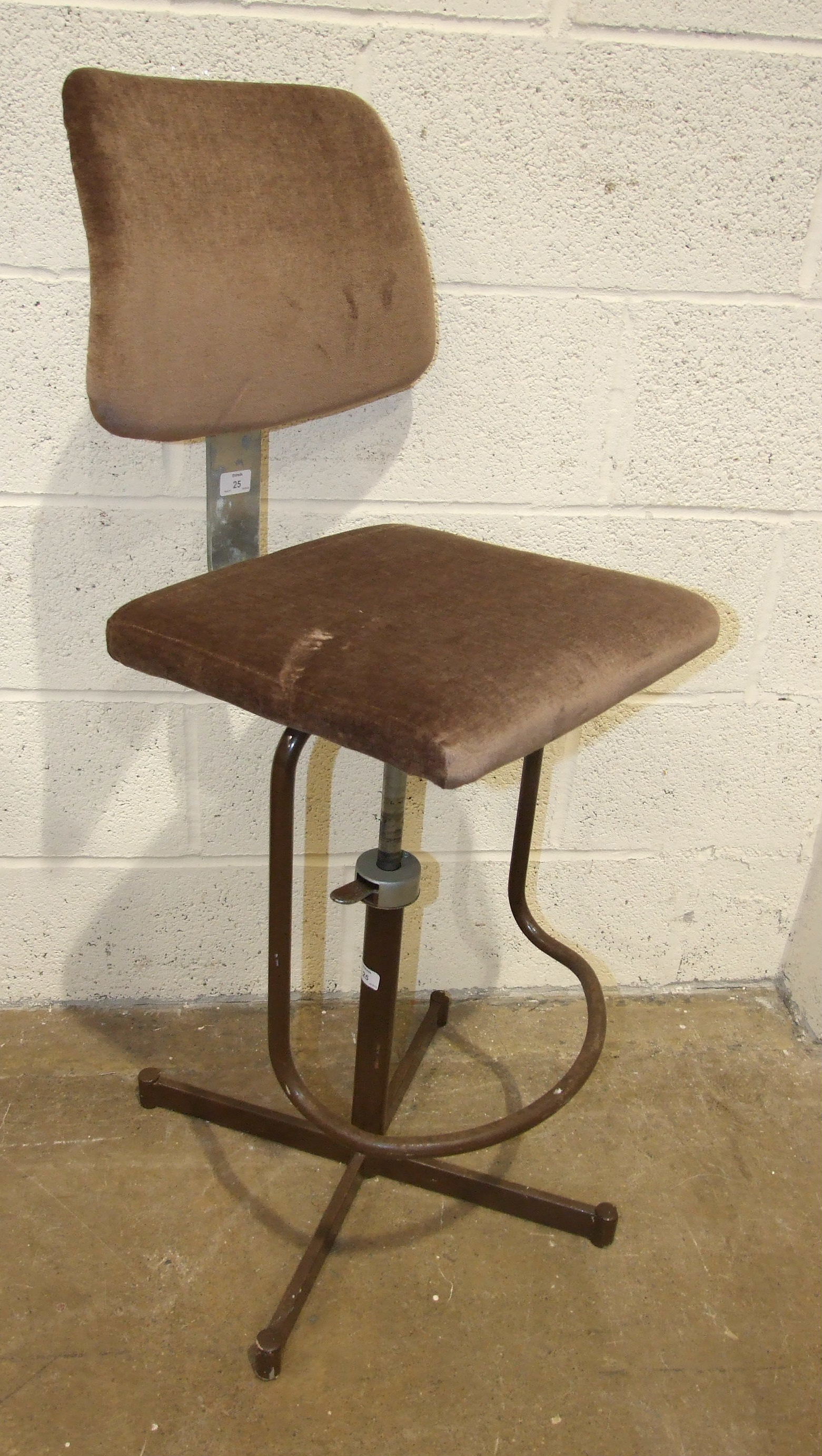 A 1970's operator's painted metal adjustable chair.