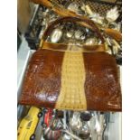 A quantity of plated cutlery, a crocodile skin handbag with matching purse, a wooden-handled carving