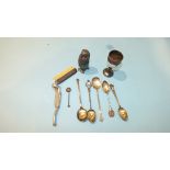 A silver egg cup, three silver shooting trophy teaspoons and two other silver spoons, weight ___3oz,