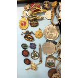 A quantity of enamelled badges, medallions, cufflinks and watches.