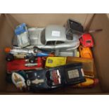 A small collection of diecast cars, alarm clocks and miscellaneous items.