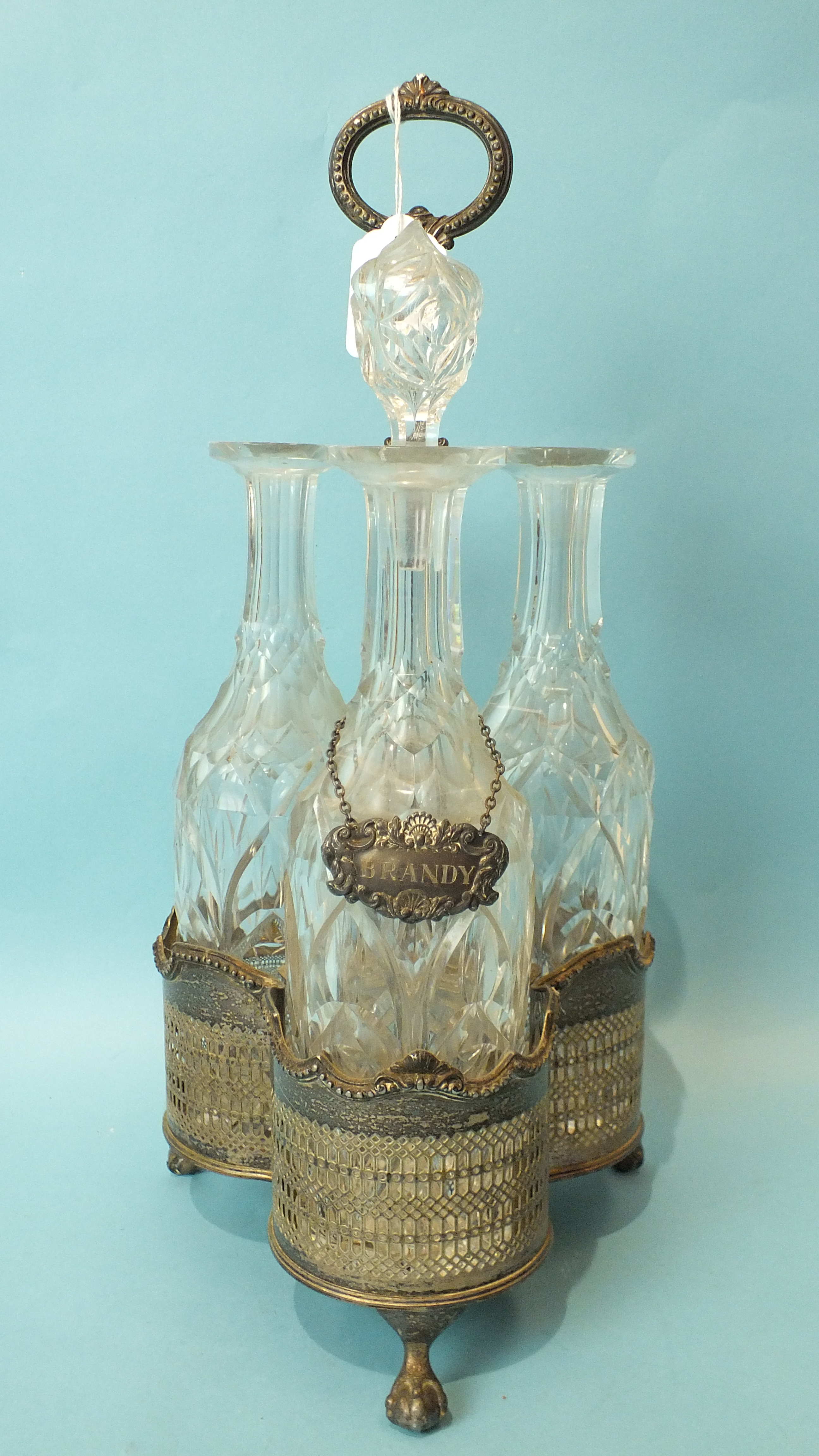 A silver plate 3-bottle decanter stand with three cut glass decanters (two stoppers missing), one