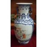 A 20th century Chinese baluster-shaped blue and white vase decorated with polychrome panels of