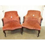 A pair of Edwardian walnut framed upholstered low salon chairs, (2).