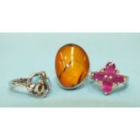 A ruby and diamond point cluster ring with silver mount, a silver ring set two opals, (one setting