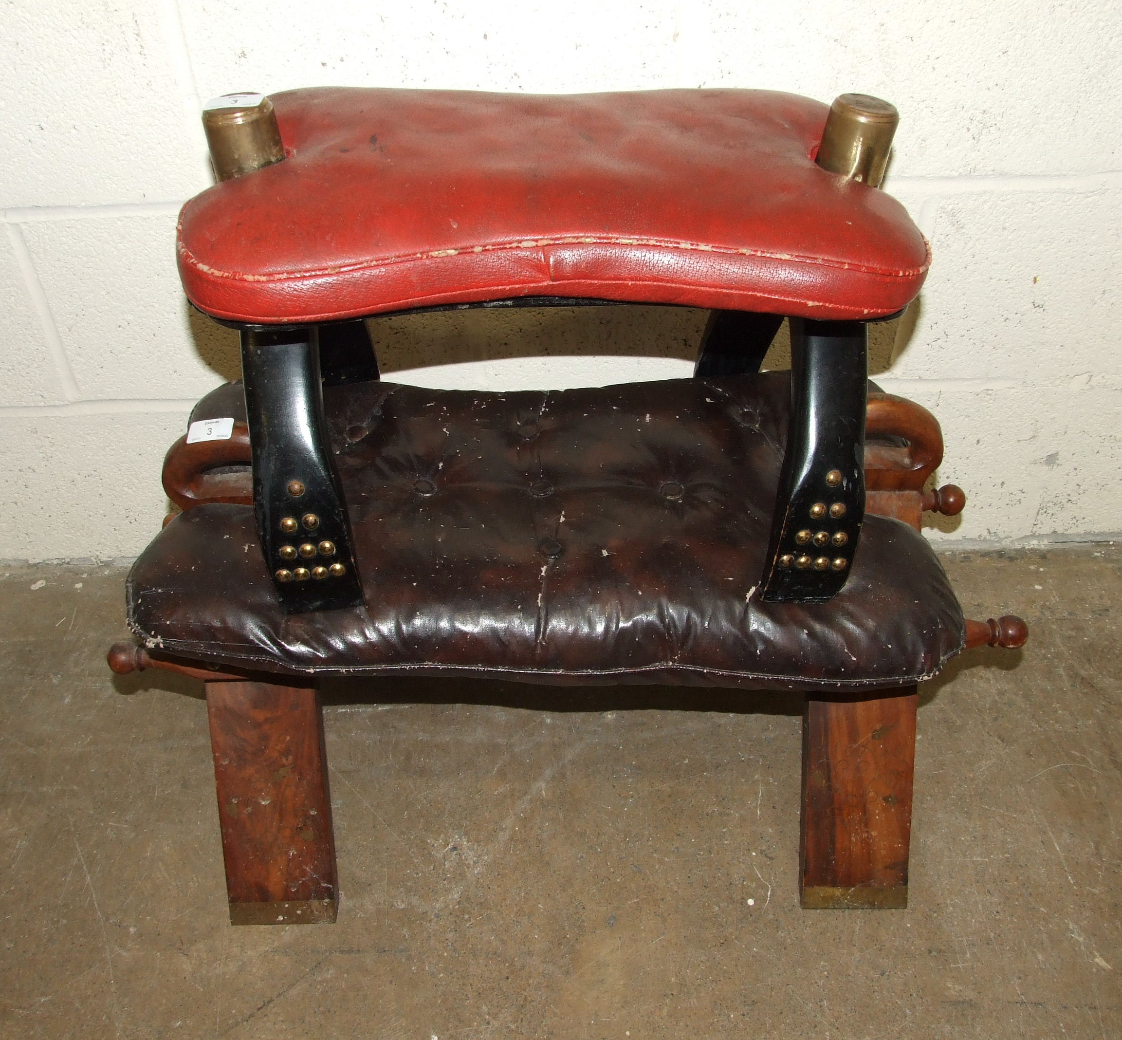 Two camel seats, one with brass-studded decoration, (2).