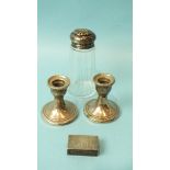 A pair of loaded silver short candle holders, 7cm high, Birmingham, 1955, a small engraved silver