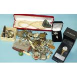 A small collection of costume jewellery, military cap badges and other items.