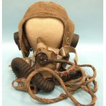 A WWII pilot or airman's Airtex flying helmet, with ear phones and rubber oxygen mask.