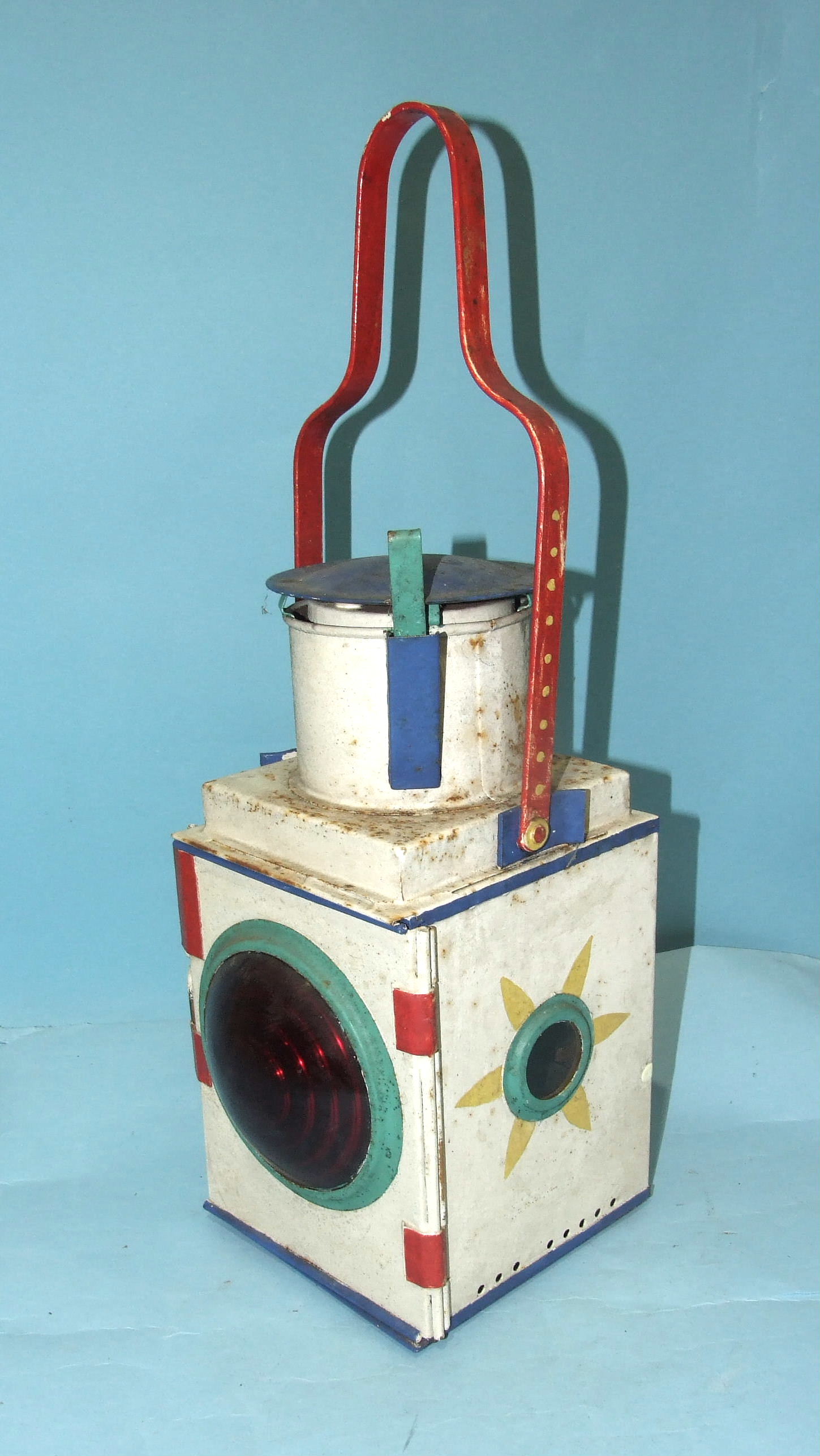 A vintage British Rail painted tail signal lamp with red bullseye lens and burner, 53cm high.