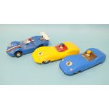 Two Triang Scalextric Lister Jaguar model slot cars, no.s 4 (yellow) and 8 (blue), with drivers