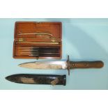 A WWII wood-handled fighting knife with single-sided 18cm blade, in metal scabbard, with offset belt