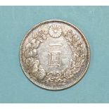 A Japanese silver one Yen coin, weighs 26.8g.