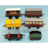 Hornby O Gauge, two coaches, a Blue Circle Portland Cement Wagon, two other wagons and a tender, a