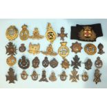 A collection of thirty-two brass and other metal military badges.