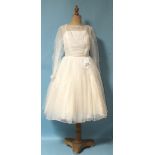 A 1960's vintage wedding dress, with ruched gauze bodice and full three-quarter length skirt